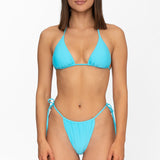 Front view of model wearing matching crystal blue Mila triangle bikini top and string bikini bottom by Aventura Swimwear.
