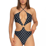 Model wearing black monogram print halter neck high leg cut Sophia one piece swimsuit by Aventura Swimwear.