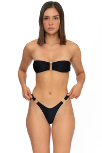 Front view of model wearing midnight black bandeau Lola bikini top and matching Brazilian cut bikini bottom by Aventura Swimwear. 