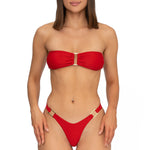 Front view of model wearing scarlet red bandeau Lola bikini top and matching Brazilian cut bikini bottom by Aventura Swimwear. 