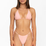 Front view of model wearing matching sunset peach Mila triangle bikini top and string bikini bottom by Aventura Swimwear. 