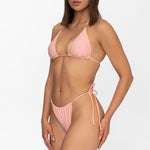 Front view of model wearing matching sunset peach Mila triangle bikini top and string bikini bottom by Aventura Swimwear. 