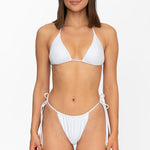 Front view of model wearing matching white Mila triangle bikini top and string bikini bottom by Aventura Swimwear. 