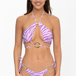 Front view of model wearing lilac and purple Sunset Safari print halter neck Nisa bikini top and matching adjustable Brazilian cut Nisa bikini bottom by Aventura Swimwear. 