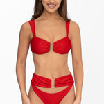 Front view of model wearing ruby red Seraphina bralette bikini top and matching high waist cheeky cut Seraphina bikini bottom by Aventura Swimwear. 