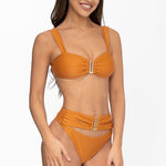 Front view of model wearing terra glow Seraphina bralette bikini top and matching high waist cheeky cut Seraphina bikini bottom by Aventura Swimwear. 