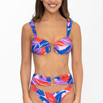 Front view of model wearing pink and purple Tropical Dusk print Seraphina bralette bikini top and matching high waist cheeky cut Seraphina bikini bottom by Aventura Swimwear. 