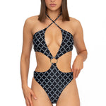 Model wearing black monogram print halter neck high leg cut Sophia one piece swimsuit by Aventura Swimwear. 