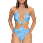 Model wearing blue monogram print halter neck high leg cut Sophia one piece swimsuit by Aventura Swimwear. 